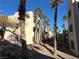 View of apartment building exterior with palm trees and walkways at 2076 Mesquite Ln # 302, Laughlin, NV 89029