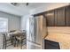 Eat-in kitchen with stainless steel refrigerator and dark cabinets at 2132 Petersham Ct # D, Las Vegas, NV 89108