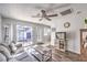 Living room with gray couch, wood floors, and view of patio at 2132 Petersham Ct # D, Las Vegas, NV 89108