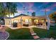 Evening view of backyard oasis with pergola, dining area, and string lights at 2228 Lucerne Ct, Henderson, NV 89014