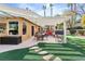 Covered patio with seating area, grill, and artificial turf at 2228 Lucerne Ct, Henderson, NV 89014