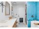 Bathroom with light wood cabinets and blue tile shower at 2228 Lucerne Ct, Henderson, NV 89014