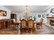 Elegant dining room features a large table, chandelier, and hardwood floors at 2228 Lucerne Ct, Henderson, NV 89014