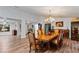 Open concept dining room with hardwood floors and a view into other rooms at 2228 Lucerne Ct, Henderson, NV 89014