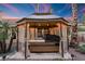 Relaxing hot tub under a covered gazebo with string lights at 2228 Lucerne Ct, Henderson, NV 89014