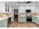 Modern kitchen with green shaker cabinets and a large island at 2228 Lucerne Ct, Henderson, NV 89014