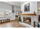 Living room with a stone fireplace and wood-look floors at 2228 Lucerne Ct, Henderson, NV 89014