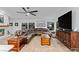 Spacious living room with brown leather sectional sofa at 2228 Lucerne Ct, Henderson, NV 89014