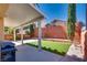 Covered patio, artificial turf, and a brick wall at 2245 Juniper Berry Dr, Las Vegas, NV 89134