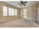 Carpeted Primary bedroom with ceiling fan and ensuite bath at 2245 Juniper Berry Dr, Las Vegas, NV 89134