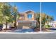 Tan two-story house with attached garage and landscaping at 2245 Juniper Berry Dr, Las Vegas, NV 89134