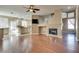 Living room with hardwood floors, fireplace, and kitchen access at 2245 Juniper Berry Dr, Las Vegas, NV 89134