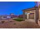 Landscaped backyard with artificial turf and a covered patio at 2376 Switchback Valley St, Las Vegas, NV 89138