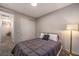 Simple bedroom with a queen-size bed and adjacent hallway at 2376 Switchback Valley St, Las Vegas, NV 89138