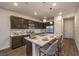 Modern kitchen with dark cabinetry and a large island at 2376 Switchback Valley St, Las Vegas, NV 89138