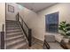 Modern staircase with metal railing and grey carpeting at 2376 Switchback Valley St, Las Vegas, NV 89138