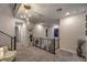 Open upper hallway with metal railing and modern light fixture at 2376 Switchback Valley St, Las Vegas, NV 89138