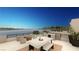 Waterfront patio with seating and fire pit at 28 Heron Harbour Dr, Henderson, NV 89011