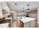 Modern kitchen with large island, stainless steel appliances, and white cabinets at 2844 Alenga St, Henderson, NV 89044