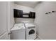 Bright laundry room with washer, dryer, and extra storage cabinets at 2844 Alenga St, Henderson, NV 89044