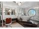 Modern bathroom with a freestanding tub, marble accents, and a vintage barber chair at 2857 Paradise Rd # 2203, Las Vegas, NV 89109