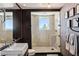 Modern bathroom with glass shower, dark tile, and large window at 2857 Paradise Rd # 2203, Las Vegas, NV 89109