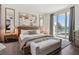 Bright and airy main bedroom with a king-size bed and floor-to-ceiling windows at 2857 Paradise Rd # 2203, Las Vegas, NV 89109