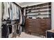 Custom walk-in closet with dark wood shelving and drawers at 2857 Paradise Rd # 2203, Las Vegas, NV 89109