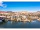 Expansive aerial view of Lake Las Vegas featuring resort buildings, a pool, and water under a bright blue sky at 29 Falling Ridge Ln, Henderson, NV 89011