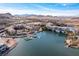 Spectacular aerial view of a lakeside community with mountains, docks, and beautiful architecture under a clear blue sky at 29 Falling Ridge Ln, Henderson, NV 89011