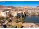 Scenic aerial view of Lake Las Vegas bridge apartments overlooking the lake surrounded by green trees and mountains at 29 Falling Ridge Ln, Henderson, NV 89011