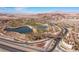 Panoramic aerial view of Lake Las Vegas entrance sign with golf course and roadways under a clear blue sky at 29 Falling Ridge Ln, Henderson, NV 89011