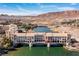 Striking aerial view of Lake Las Vegas bridge apartments over the water, backed by desert mountains and blue skies at 29 Falling Ridge Ln, Henderson, NV 89011