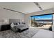 Main bedroom with sliding doors opening to a patio with lake views at 29 Falling Ridge Ln, Henderson, NV 89011