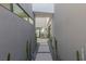 Pathway lined with cacti leading to a tranquil courtyard at 29 Falling Ridge Ln, Henderson, NV 89011