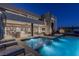 Expansive pool and spa with outdoor seating at night at 29 Falling Ridge Ln, Henderson, NV 89011