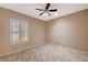 Bright bedroom with ceiling fan, tile floors and window shutters at 3004 Canton Hills St, Henderson, NV 89052