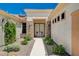 Elegant entryway with decorative iron doors and desert landscaping at 3004 Canton Hills St, Henderson, NV 89052