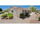 Tan house exterior with a landscaped yard and a covered patio at 3004 Canton Hills St, Henderson, NV 89052