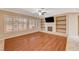 Living room with hardwood floors, fireplace, and built-in shelving at 3004 Canton Hills St, Henderson, NV 89052