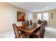 Formal dining room with large wood table, chairs, and decorative wall art at 3158 Biancavilla Ave, Henderson, NV 89044