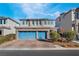 Three-car garage, stone accents, and landscaping highlight this inviting home exterior at 358 Terrill Ave, Las Vegas, NV 89183