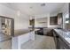 Modern kitchen with dark cabinetry, granite counters, and large island at 358 Terrill Ave, Las Vegas, NV 89183