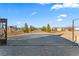 Long gravel driveway leading to a large house with trees lining the sides at 3720 W Charleston Park Ave, Pahrump, NV 89048