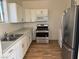 Bright kitchen with white cabinets, stainless steel appliances, and wood-look floors at 3720 W Charleston Park Ave, Pahrump, NV 89048