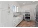 Clean kitchen with white cabinets, stainless steel appliances, and wood flooring at 3720 W Charleston Park Ave, Pahrump, NV 89048