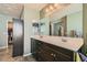 Main bathroom with double sinks, large mirror, and walk-in closet at 4650 Ranch House Rd # 42, North Las Vegas, NV 89031