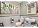 Charming half bathroom with pedestal sink and decorative mirror at 4650 Ranch House Rd # 42, North Las Vegas, NV 89031