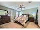 Serene bedroom with leafy bedding, ceiling fan, and ample closet space at 4650 Ranch House Rd # 42, North Las Vegas, NV 89031