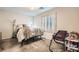 Neutral toned bedroom offering natural light from window with coverings and a floor lamp at 4650 Ranch House Rd # 42, North Las Vegas, NV 89031